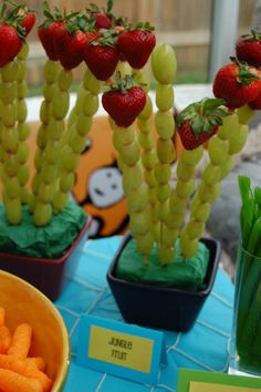 some strawberries and carrots are on the table