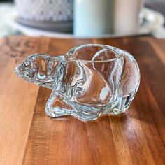 a glass dog figurine sitting on top of a wooden table