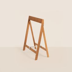 a wooden easel sitting on top of a white floor