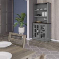 the dining room table is set with white plates and silverware, along with a gray bookcase