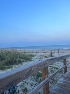 a wooden walkway leading to the beach