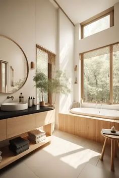 a large bathroom with two sinks and a bathtub in the corner, along with a round mirror on the wall