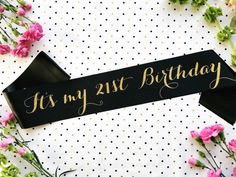 it's my 21st birthday sign on a table with flowers and polka dot paper