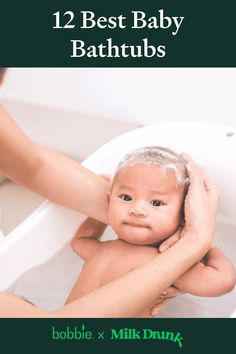 the baby is taking a bath in the tub with his mother's arm around him