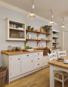 the kitchen is clean and ready to be used for dinner or lunchtime, with white cabinets and open shelvings