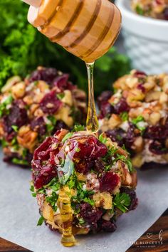 beet and cranberry salad with honey drizzled over it on top