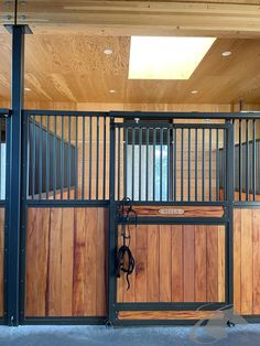 the inside of a horse stable with wooden walls