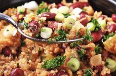 a spoon full of rice with beans and vegetables