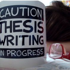 a woman is holding a coffee mug that says caution, this is writing in progress