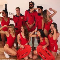 a group of people in red swimsuits posing for a photo