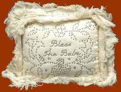 an embroidered pillow with fringes and beads