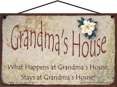 a sign that says grandma's house with a flower on the front and back