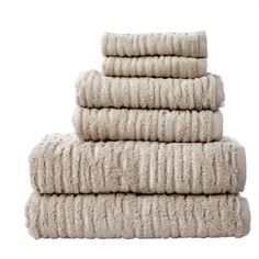 four white towels stacked on top of each other in front of a white background,