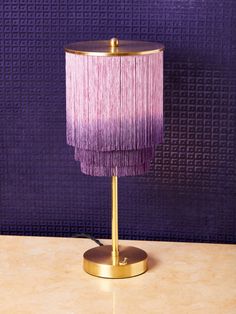 a table lamp with a purple shade on it