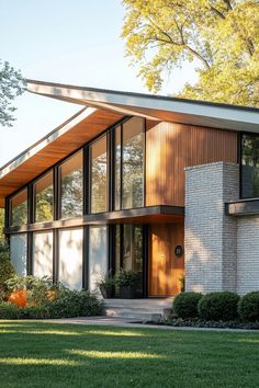 a modern house with large windows and wooden roof