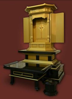 an old fashioned clock is sitting on top of a table