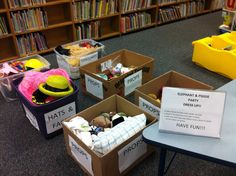 several cardboard boxes filled with items in a library