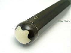 a black and white pen on a white surface