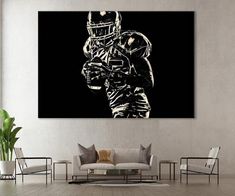 three black and white football players on canvass in a living room with couches