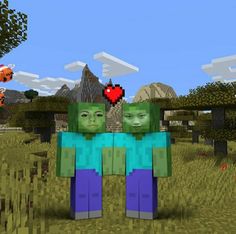 two people standing next to each other in front of some trees and rocks with hearts on them