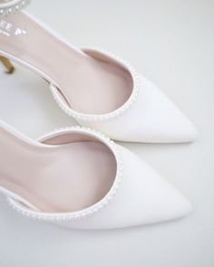 Classic satin pointy toe heels with an added touch for romantic, elegant and feminine look. The prettiest pearl details on this elegant satin heel checks off all the right boxes. The delicate mini pearl beads are placed carefully by hand to create a graceful classic bridal shoe. Perfect for brides, bridal party, bridesmaids, prom, parties, or any special occasion. DETAILS: HEELS: 3 inches COLORS AVAILABLE: Ivory and White UPPER: Synthetic upper and lining MATERIALS: Manmade outsole ORIGIN: Imported STYLE NAME: BELL Pearl Wedding Heels Bride Shoes, Wedding Shoes Bride Block Heel, Pearl Wedding Heels, Wedding Heels Brides, Bride Shoes Low Heel, Ivory Bridal Shoes, Bridal Shoe, Formal Heels, Pearls Wedding