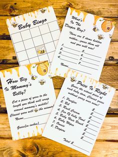 three bee themed baby shower games on top of a wooden table