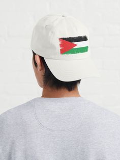 a man wearing a white hat with the flag of jordan painted on it's side