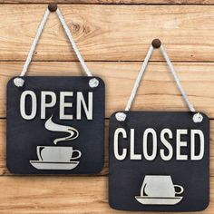 two signs that say open and closed with coffee cups