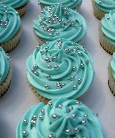 cupcakes with blue frosting and silver decorations