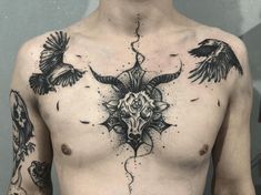 a man's chest with tattoos and birds on it