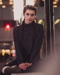 an instagram page with a woman in black sweater