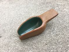 a wooden spoon sitting on top of a cement floor