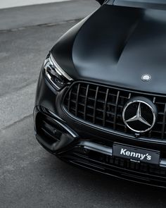 the front end of a black mercedes suv