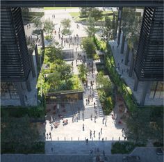 an aerial view of people walking and sitting on benches in the middle of a courtyard