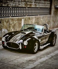 a black and white sports car parked on the street