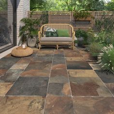 an outdoor patio with stone tiles and plants