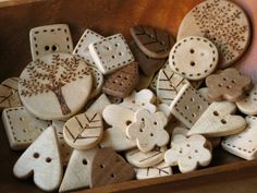 several wooden buttons with designs on them