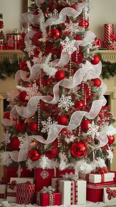 a christmas tree decorated with red and white ribbons, bows, ornaments and snowflakes