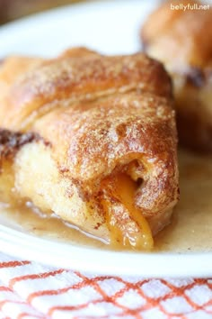 two pastries sitting on top of a white plate