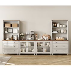 a kitchen with white cabinets and shelves filled with dishes, coffee cups and other items