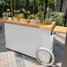 an outdoor bar with drinks on it and wheels for the backgroung to go