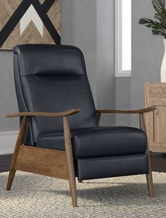 a black leather recliner chair in a living room with a wood frame and armrests