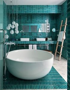 a large white bath tub sitting inside of a bathroom