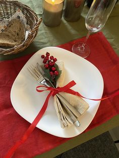 a white plate topped with food next to a candle