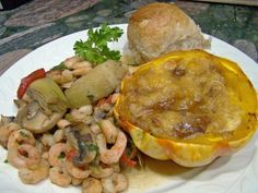 a white plate topped with food next to a roll