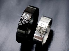 two wedding rings with engraved designs on them