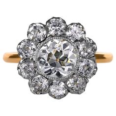 This breathtakingly beautiful, darling, early-twentieth century Edwardian Flower shaped, Cluster Ring finely hand crafted in platinum over 18 karat yellow gold. The Center Diamond is an OLD EUROPEAN Cut 1.57ct in J color, SI1 clarity, accompanied with GIA certificate. The diamond faces up very well and looks warm white in natural light , no obvious imperfections to the naked eye.. The measurements are 7.02x7.24x4.50mm, these Old Euro Rounds are so magical! The facets are large, chunky and beauti Diamond Outline, Gia Certificate, Diamond Face, Right Hand Rings, Luz Natural, Cluster Ring, Flower Shape, Ring Verlobung, Warm White