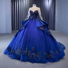 a blue ball gown with flowers on the skirt