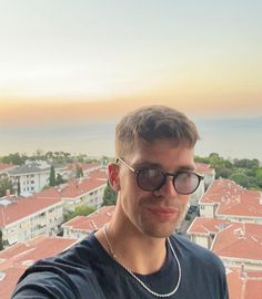 a man taking a selfie on top of a building