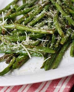 asparagus with parmesan cheese on top and sprinkles in the middle